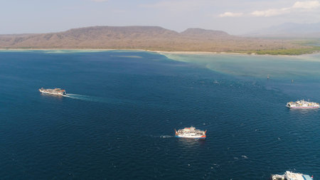 Aerial view ferry port gilimanuk with ferry boats, vehicles. Ferries transport vehicles and passengers in port. Port for departure from Bali to the island of Java.の写真素材