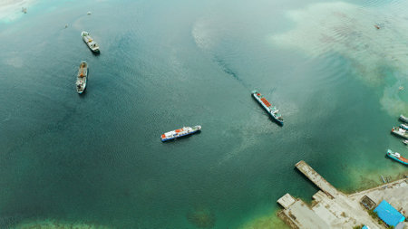 Freight ships and ferries in the bay, top view. Dapa Ferry Terminal. Siargao, Philippines.