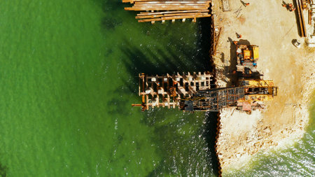 Pile driver hammer in action. Construction bridge over the sea bay on the tropical island of Siargao.の写真素材