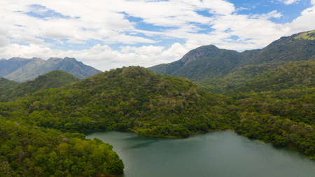 A beautiful lake among the mountains with forest and tropical vegetation. Randenigala reservoir.の写真素材