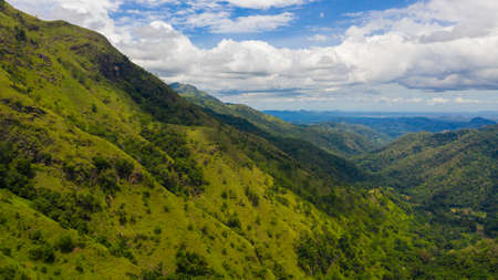 Aerial view of Mountains covered rainforest, trees and blue sky with clouds. Ella Rock, Sri Lanka.の写真素材