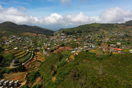 Aerial view of Houses among tea plantations on the slopes of the mountains. Nuwara Eliya, Sri Lanka....