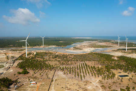 Wind turbines for electric power production on the seashore. Wind power plant. Ecological landscape....
