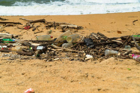 Plastic and wood waste on the beach pollute the environment. Negombo, Sri Lanka.