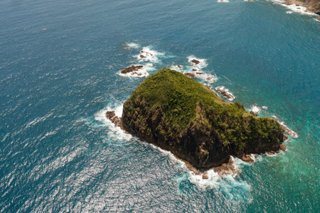 Aerial drone of waves crashing on a rocky island. Santa Ana, Cagayan. Philippines.の写真素材