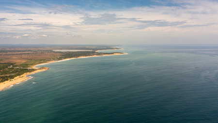 Aerial drone of coastline of Sri Lanka island with a beach and ocean. Tropical vegetation and agricultural land.の写真素材