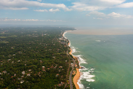 Beautiful beach, palm trees by turquoise water view from above. Hikkaduwa, Sri Lanka.の写真素材