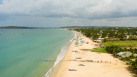 Sri Lanka - August 25, 2021: Aerial view of group of fishermen pulling nets from the sea. Trincomalee.のeditorial素材