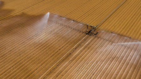 aerial view Center pivot agriculture irrigation machine of crops. An irrigation pivot watering agricultural land. Irrigation system watering farm land.の写真素材