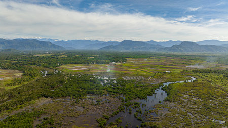 Farmland and mountains with blue sky. Sumatra. Indonesia.の写真素材