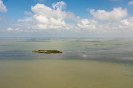 Aerial view of Tropical island and blue sea against the sky and clouds.の写真素材