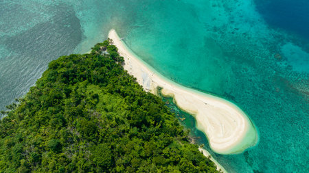 Aerial view of beautiful beach on a tropical island and blue sea. Agutaya island, Philippines.