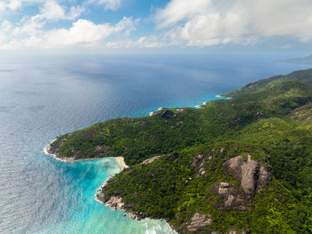 Bay with pristine beach, coral reefs and vibrant green forest cover. Seychelles, Mahe.の写真素材