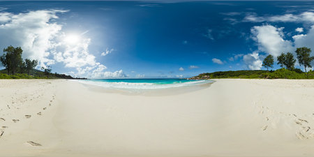 Tropical beach with massive boulders, gentle waves, and soft white sand surrounded by lush greenery....