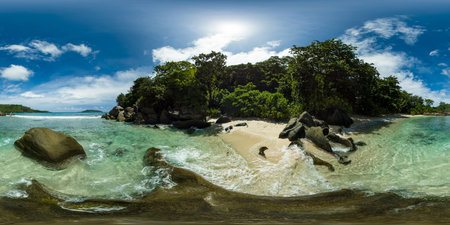 A picturesque cove with beach, rocky outcrops, and vibrant green foliage. Mahe, Seychelles. VR 360.の写真素材