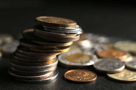 Many coins on a black background. Close-up