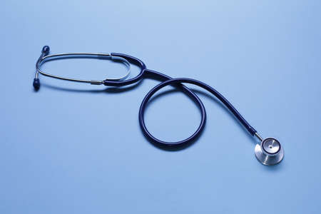 Blue stethoscope on blue background