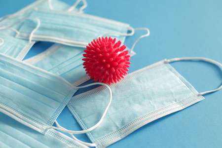 Viral Coronavirus Bacteria And Protective Medical Disposable Masks On A Blue Background. Concept Of...