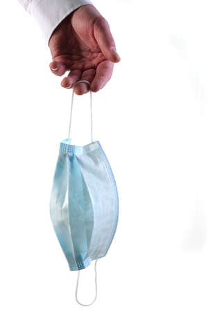 Close-Up Of Hand Holding Surgical Protective Medical Mask