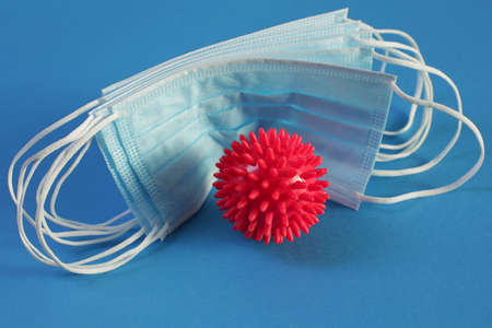 Viral Coronavirus Bacteria And Protective Medical Disposable Masks On A Blue Background. Concept Of...
