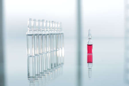 Vaccine vials on glass table in hospitalの写真素材