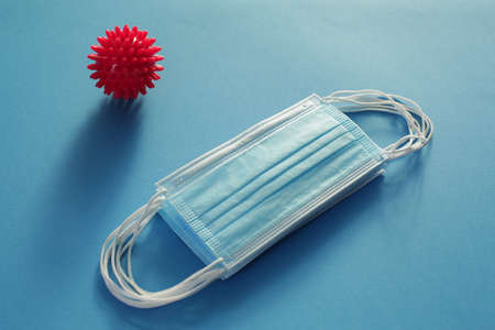 Viral Bacteria And Protective Medical Disposable Masks On A Blue Background. Concept Of Air Pollution , Pneumonia Outbreaks, Epidemics , And Prevention Of The Risk Of Biological Pollutionの写真素材