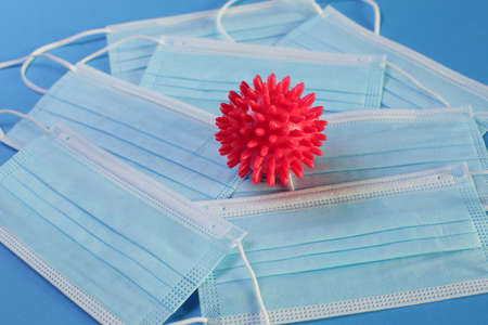 Viral Bacteria And Protective Medical Disposable Masks On A Blue Background. Concept Of Air...