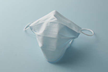 Respiratory medical masks on blue background. Protective medical mask. Coronavirus protection concept.の写真素材