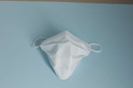Respiratory medical masks on blue background. Protective medical mask. Coronavirus protection concept.の写真素材