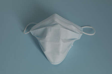 Respiratory medical masks on blue background. Protective medical mask. Coronavirus protection concept.の写真素材