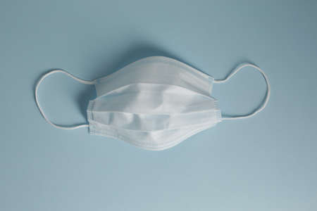Respiratory medical masks on blue background. Protective medical mask. Coronavirus protection concept.の写真素材
