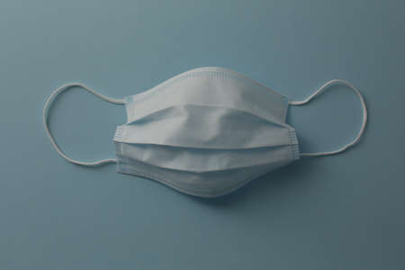 Respiratory medical masks on blue background. Protective medical mask. Coronavirus protection concept.の写真素材