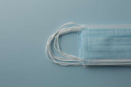 Respiratory medical masks on blue background. Protective medical mask. Coronavirus protection...