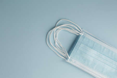 Respiratory medical masks on blue background. Protective medical mask. Coronavirus protection concept.の写真素材