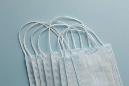 Respiratory medical masks on blue background. Protective medical mask. Coronavirus protection concept.の写真素材