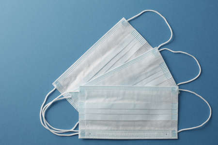 Respiratory medical masks on blue background. Protective medical mask. Coronavirus protection...