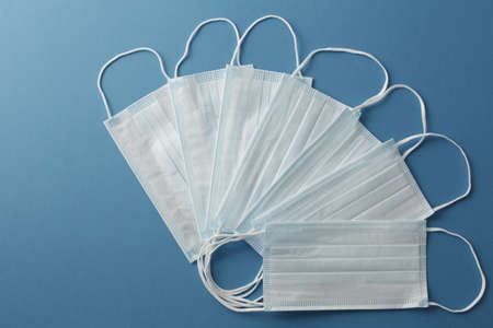 Respiratory medical masks on blue background. Protective medical mask. Coronavirus protection concept.の写真素材