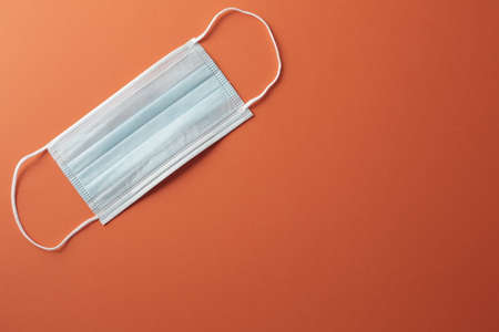 Respiratory masks on orange background. Coronavirus protection concept.の写真素材