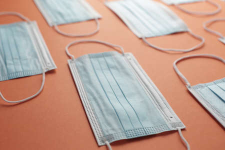 Respiratory masks on orange background. Coronavirus protection concept.の写真素材