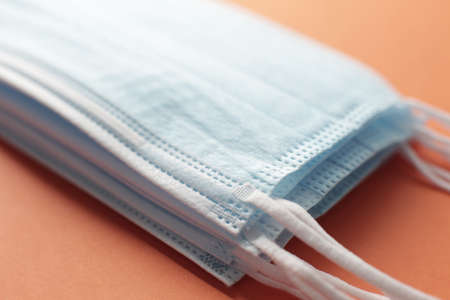 Respiratory masks on orange background. Coronavirus protection concept.の写真素材