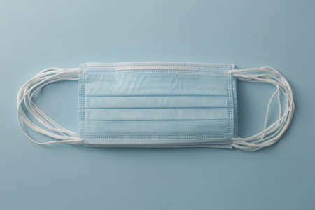 Respiratory medical masks on blue background. Protective medical mask. Coronavirus protection concept.の写真素材