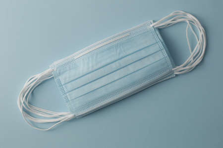 Respiratory medical masks on blue background. Protective medical mask. Coronavirus protection concept.の写真素材
