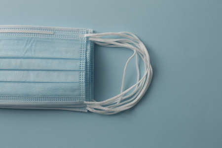 Respiratory medical masks on blue background. Protective medical mask. Coronavirus protection concept.の写真素材