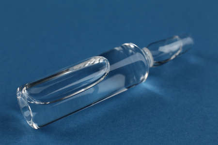 Medical vaccine vial on blue backgroundの写真素材
