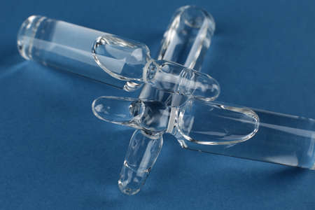 Glass vials with vaccine on blue background
