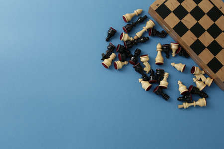 Chess wooden pieces and board on a blue backgroundの写真素材