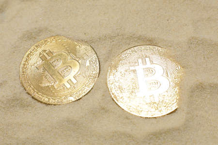 Two bitcoin coins on the sand. Close upの写真素材
