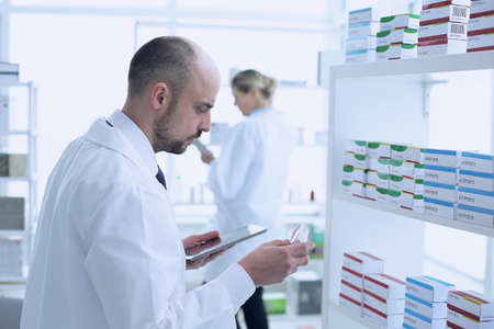 Pharmacists is Working. Man and Woman. People Wearing Special Uniform. People Located in Pharmacy.の写真素材