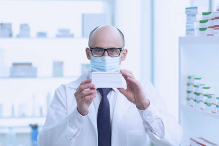 Pharmacist is Working. Man Wearing Medical Uniform. Located in Pharmacy.の写真素材