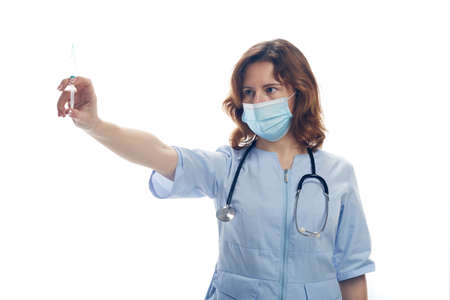 The doctor holds a syringe in his hands. Vaccination concept